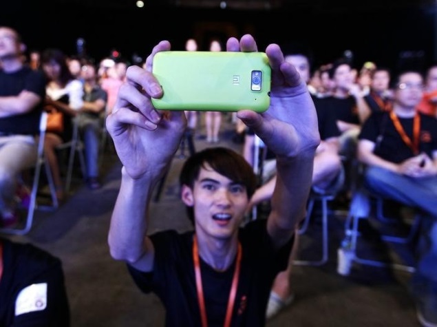man_taking_pic_with_xiaomi_phone_reuters.jpg