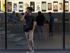 Advocates for Blind, Deaf Want More From Apple man_using_iphone_in_front_of_apple_store_ap_small.jpg
