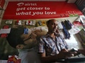 DoT clears Airtel-Qualcomm's WBSPL 4G deal man_using_mobile_in_airtel_store_reuters_small.jpg