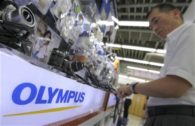 Olympus sells mobile telecom unit to fund for $676 million